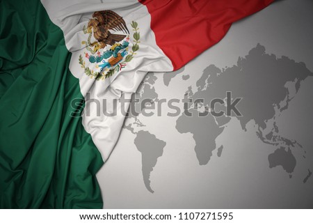 waving colorful national flag of mexico on a gray world map background.