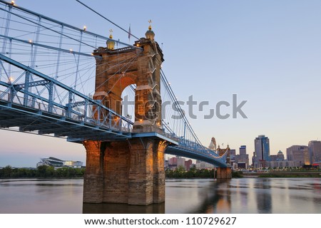 Cincinnati. Image of Cincinnati and John A. Roebling suspension bridge at twilight.