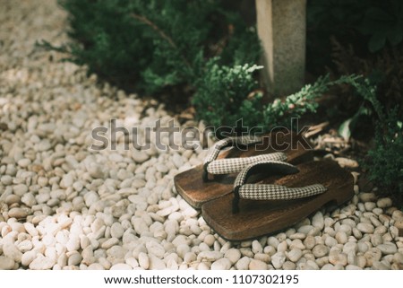 Japanese traditional sandal with the background of garden