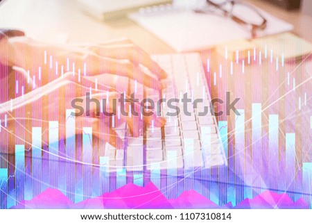 Hands using keyboard with abstract forex chart at workplace. City background. Trade and market concept. Double exposure 
