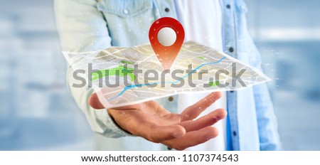 View of a Man holding a 3d rendering pin holder on a map Royalty-Free Stock Photo #1107374543
