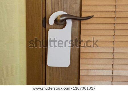 Hotel door handle with blank paper hanger