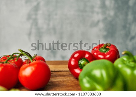 ripe tomatoes, red and green peppers on the table                          