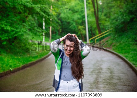 portrait of young adult woman wet after rain. smiling