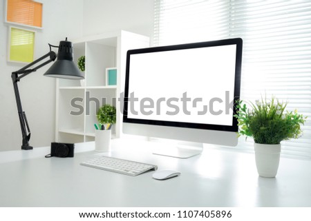 Computer all in one, keyboard, mouse, smartphone, pencils, cactus and plants vase on wooden table Royalty-Free Stock Photo #1107405896