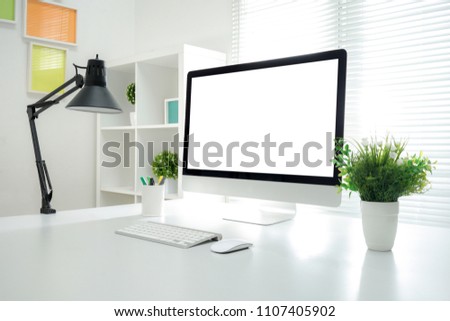 Computer all in one, keyboard, mouse, smartphone, pencils, cactus and plants vase on wooden table Royalty-Free Stock Photo #1107405902
