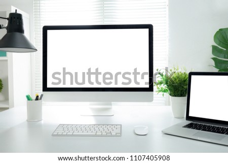 Computer all in one, keyboard, mouse, smartphone, pencils, cactus and plants vase on wooden table Royalty-Free Stock Photo #1107405908