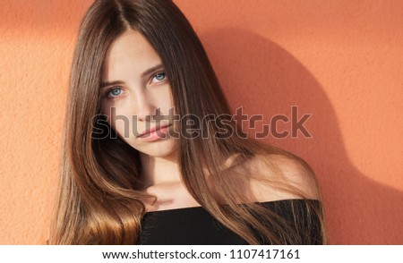 beautiful girl on orange background wall