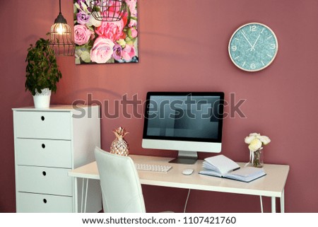 Stylish workplace interior with computer monitor on table