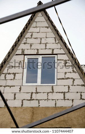 pictured in the photo a window on the roof of the house