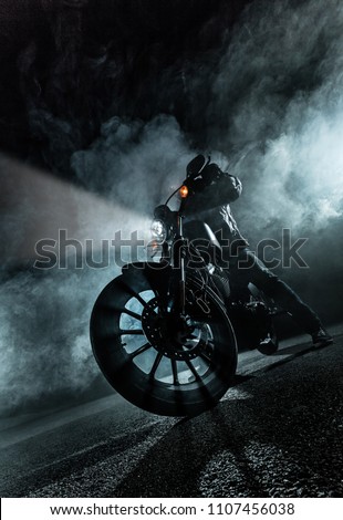 High power motorcycle at night. Smoke effect on dark background. Royalty-Free Stock Photo #1107456038