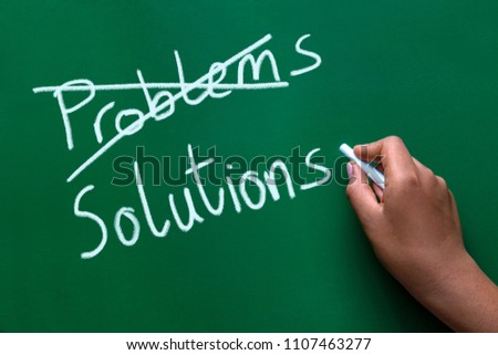 Crossing out problems and writing solutions on a blackboard.