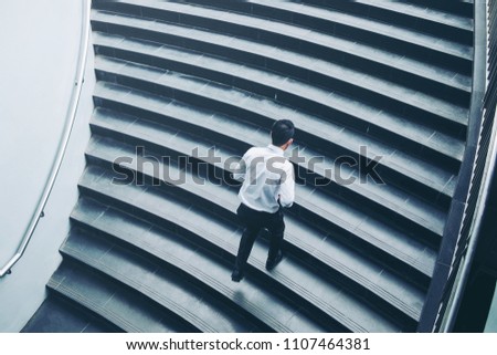 Successful businessman running fast upstairs Success concept Royalty-Free Stock Photo #1107464381