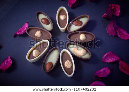 Chocolate candy with nuts on a black background