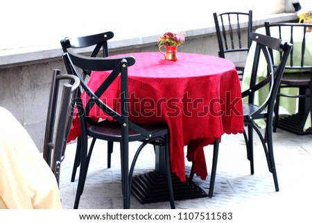restaurant table on the street in old city. Royalty-Free Stock Photo #1107511583