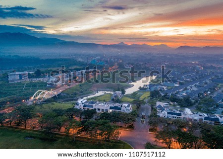 Aerial View of A Car Bridge on a River near Urban Housing Complex with Sunrise Background, Bandung, West Java, Indonesia, Asia