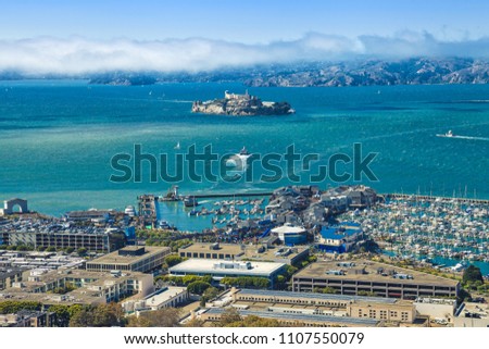 Aerial view of Alcatraz Island, Hyde Street Pier in Fisherman's Wharf and Maritime National Historical Park, from top of Coit Tower on sunny day. San Francisco, California, Unites States. Royalty-Free Stock Photo #1107550079
