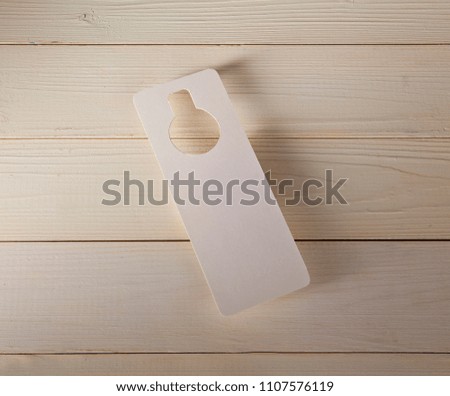 White door hanger on a wooden background