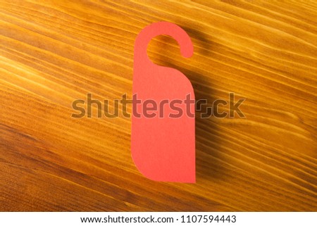 Red door hanger on a wooden background