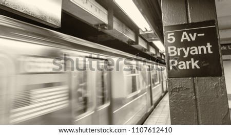 Fifth Avenue subway station with fast moving train, New York City.