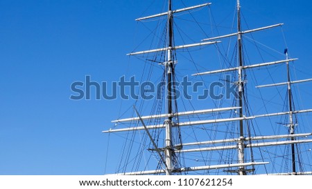 Large mast and guy wire of an old sailing ship. Copy space for text.