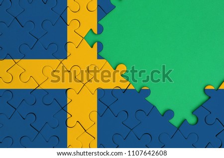 Sweden flag  is depicted on a completed jigsaw puzzle with free green copy space on the right side