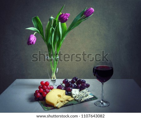 Still life with a bouquet of purple tulips and delicious snacks
