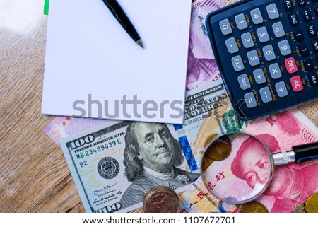 Empty blank notebook with colorful international banknotes and calculator.Management income and  saving concept.