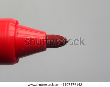 Close up of tip of red color whiteboard marker on white background