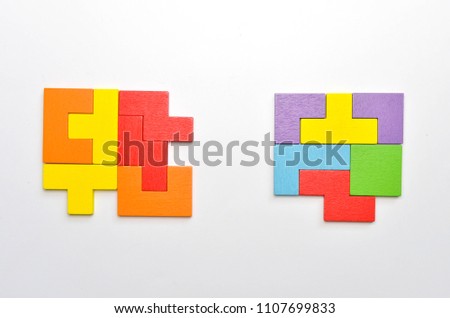 Concept of creative, logical thinking. Different colorful shapes wooden blocks on white background, flat lay, copy space. Geometric shapes in different colors, top view. Selective focus.