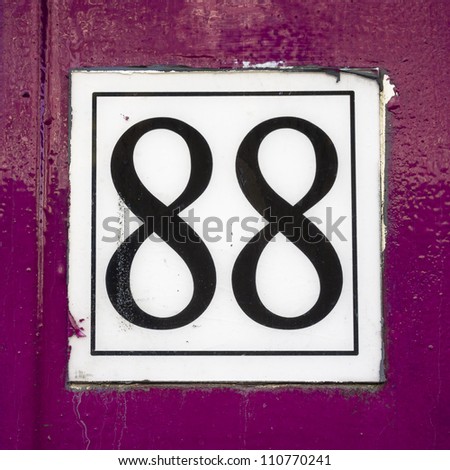 House number eighty-eight. Black lettering on a white placard