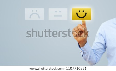 Hand of client show a feedback with smiley face card. Service rating, satisfaction concept Royalty-Free Stock Photo #1107710531