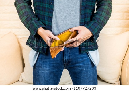 No money concept, Man hoding hand on empty wallet and empty pocket jean