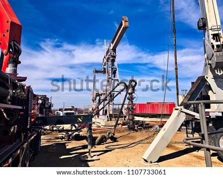 Fracking, well head connected to fracking pumps. Royalty-Free Stock Photo #1107733061