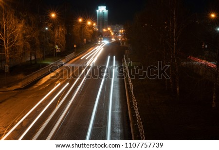 Night city. Light marks on the highway. Blurred motion.