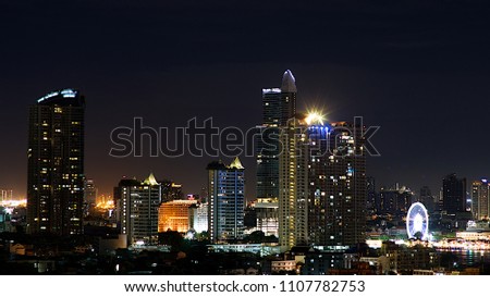Aerial view of Bangkok at night ,view on the glass window of the tower,living place in Bangkok city downtown with night, Thailand