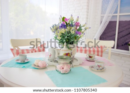 Table setting. Tea drinking. Interior in light colors. Feast