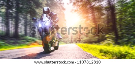 motorbike on the forest road riding. having fun driving the empty road on a motorcycle tour journey. copyspace for your individual text. Royalty-Free Stock Photo #1107812810