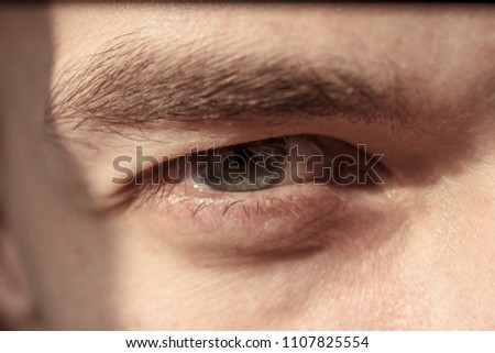 closeup - narrowed eyes of the young man