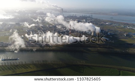 Aerial photo of nuclear power plant and cargo vessel barge moving over canal a thermal power station in which the heat source is a nuclear reactor this plant is located in a heavy industrial zone
