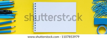 Classic Blue supplies and white notebook in yellow background with copy spice. Education, studing, office and back to school concept. Flat lay. Trendy color 2020
