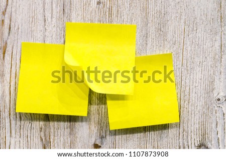 Yellow sticker paper note on white wood board