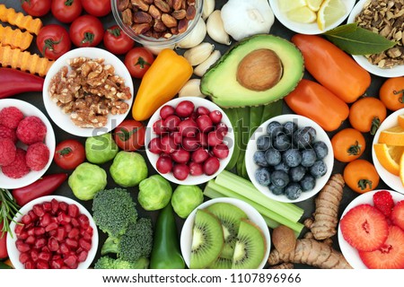 Healthy super food concept with vegetables, fruit, herbs, spice and nuts. Food very high in antioxidants, anthocyanins, omega 3, minerals and vitamins. Royalty-Free Stock Photo #1107896966