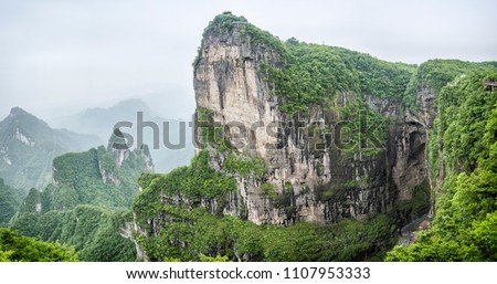 Panorama of the Tianmen Mountain Peak with a view of the cave Known as The Heaven's Gate surrounded by the green forest and mist at Zhangjiagie, Hunan Province, China, Asia