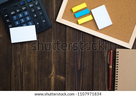 Office supplies or office work essential tools or items on wooden desk in workplace, top view with copy space for add text and message.