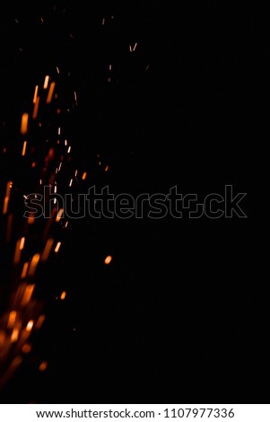 Close-up of sparks against black background.