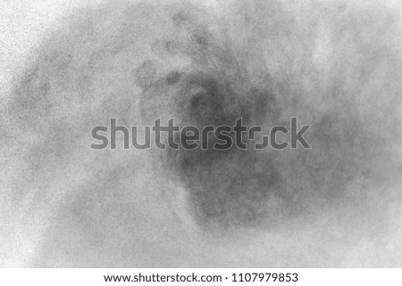Abstract black dust splatter on white background.