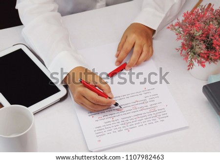 proofreading paper on white table in office Royalty-Free Stock Photo #1107982463