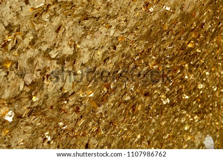 Close up picture of The surface of the holy mountain with gold leaf. For several decades. This place is in Saraburi, Thailand.