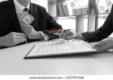 Business man give bribe to the officer concept corruption . mix color with black and white